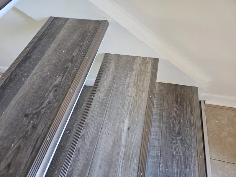 New grey wood-look stair treads with aluminium nosing